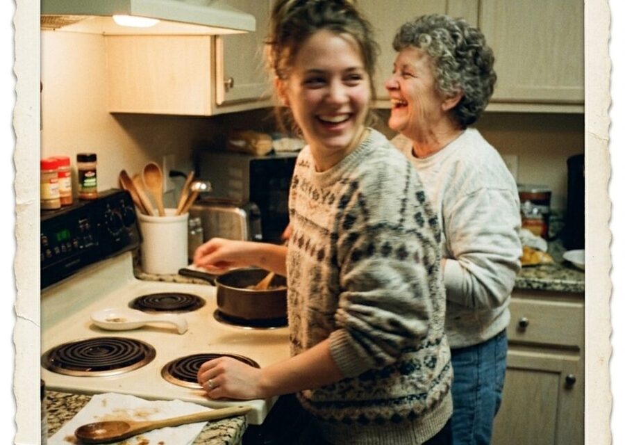 A young woman and her grandmother laughing together in a kitchen